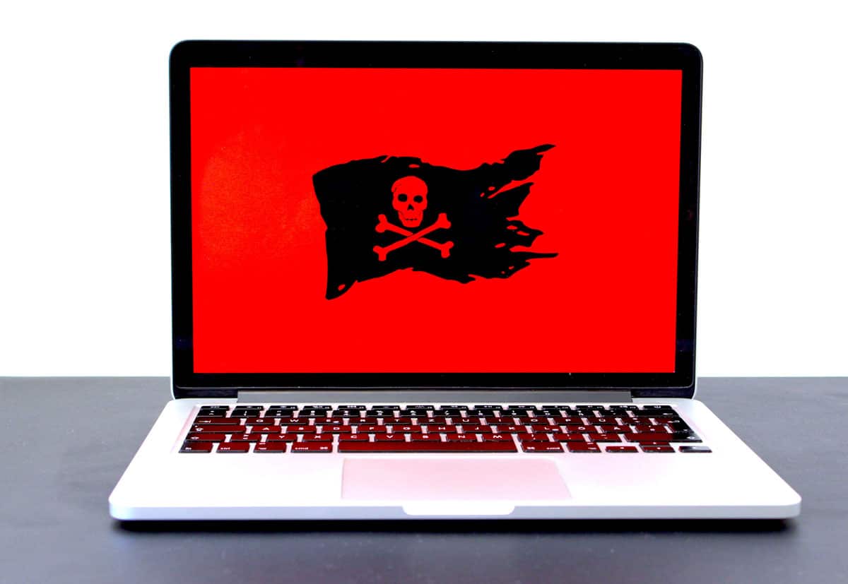 Hacked website with a red screen flying the Jolly Roger