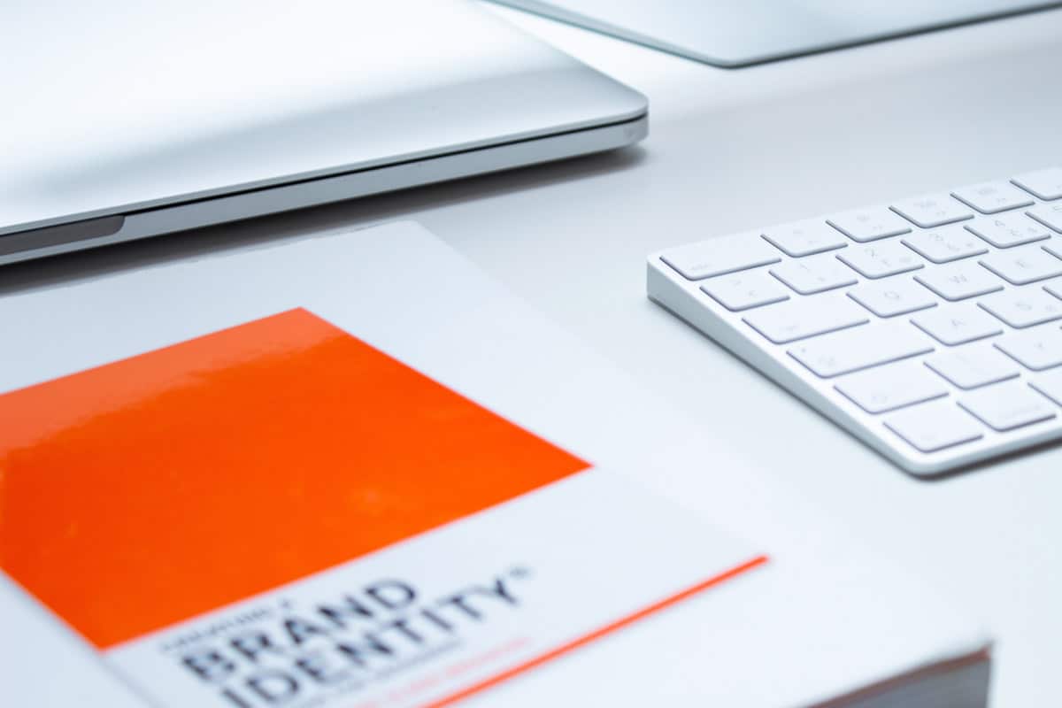 Picture of a desk with a book about Brand Identity on it.