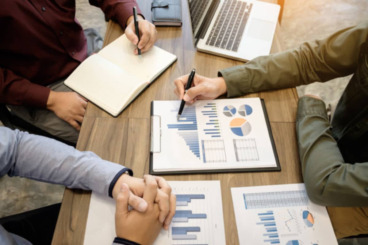 Lawyers at a table creating an online marketing plan for their law firm