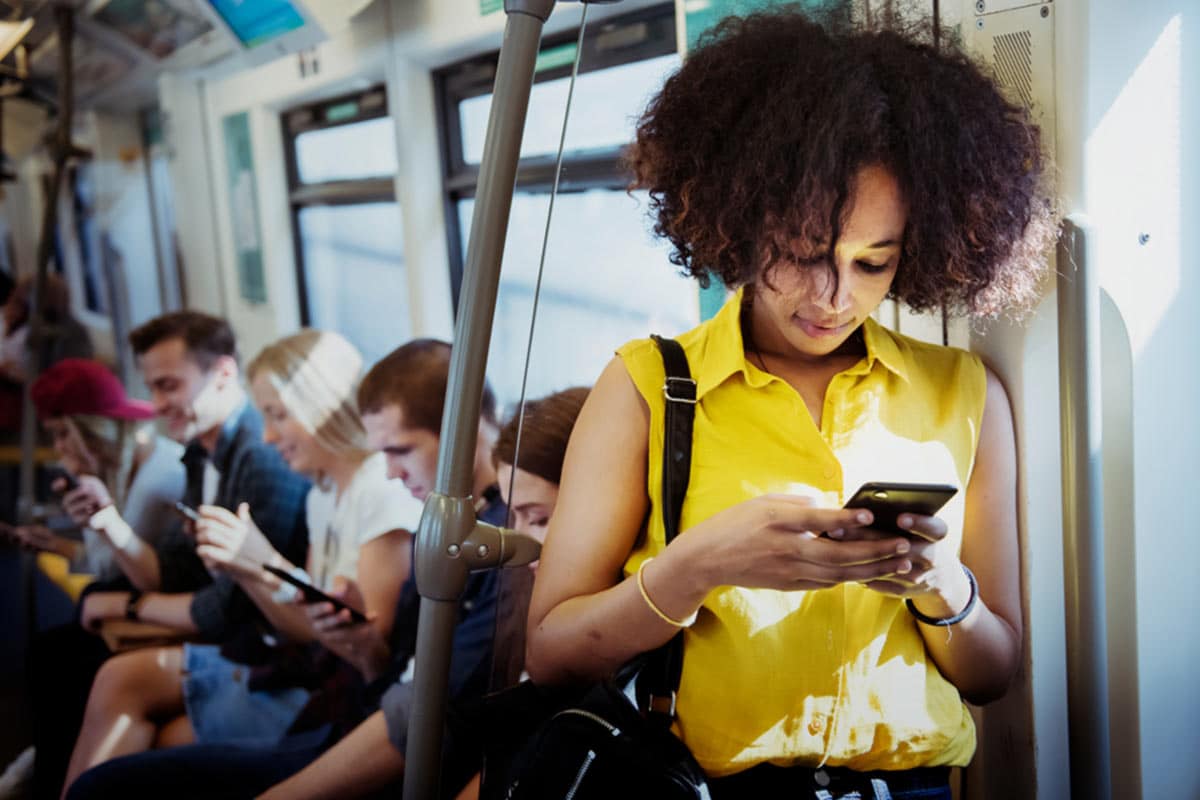 Woman using her smartphone on public transit
